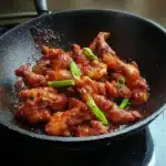 the cover of dragon chicken on a white plate with chopsticks and green onions
