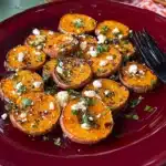 roasted sweet potato rounds with honey & feta on a baking sheet and in a casserole dish