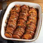 an easy and delicious sweet potato dish is served in a white bowl with whipped cream on top