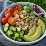 avocado and tomato salad with a fork stuck in it