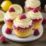 raspberry lemon heaven cupcakes with white frosting and fresh raspberries on top