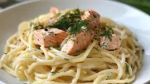 lemon dill salmon pasta on a plate with text overlay