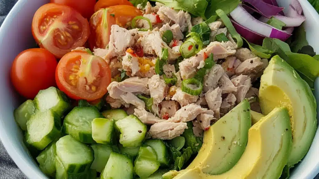 avocado and tomato salad with a fork stuck in it