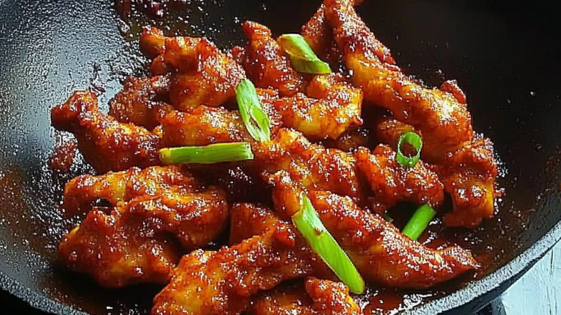 the cover of dragon chicken on a white plate with chopsticks and green onions