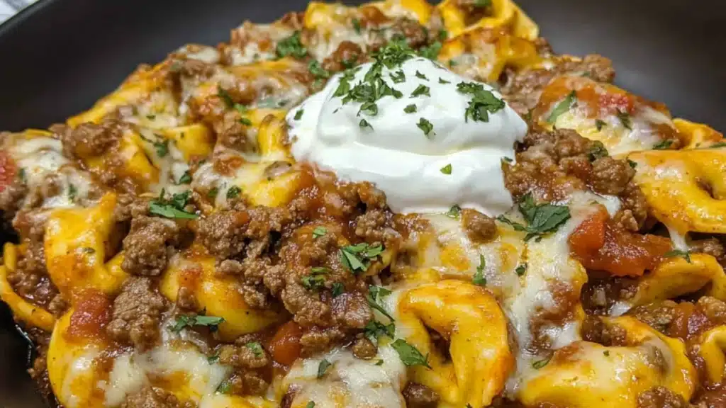cheesy beef enchilada tortellini in a white bowl